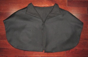 Black wool cape lined with linen. This was the stunt cape. It was in my display for all to see, including Cheryl. She didn't know I made another one of the same wool, lined with silk and decorated with her laurel badge.